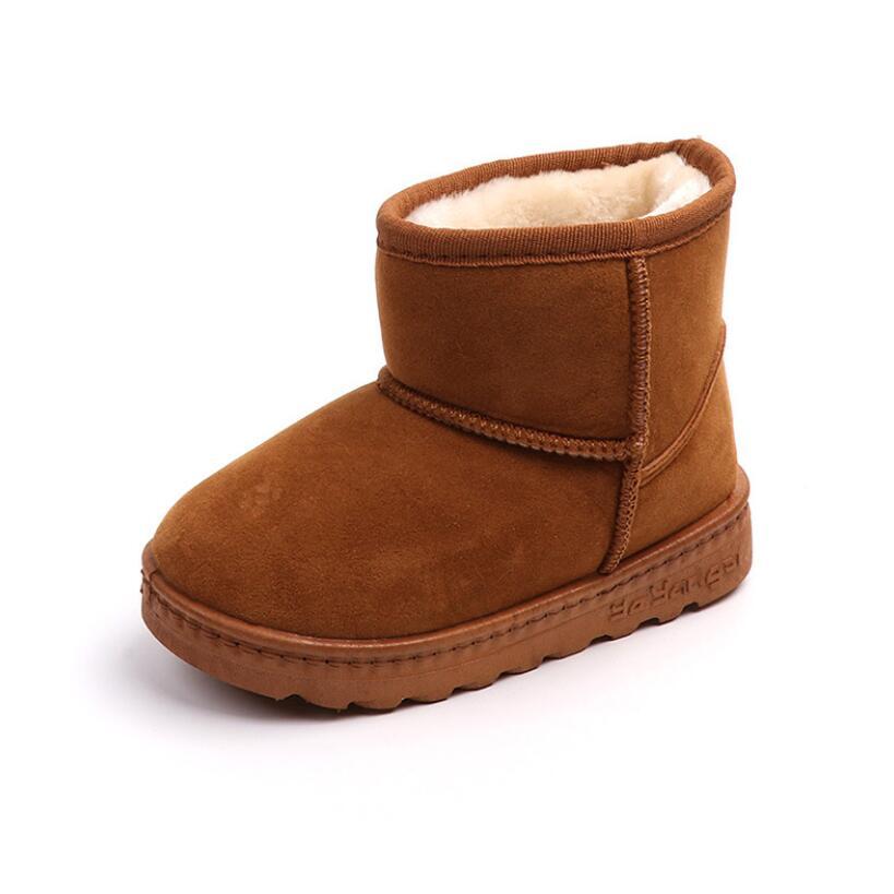 Brown children's snow boot with fur lining on a white background