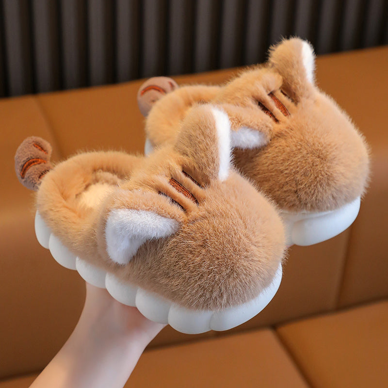 Pair of fluffy slippers with animal ears and paws on a brown surface.