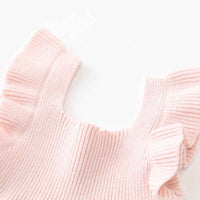 Close-up of a pink knitted sweater on a white background