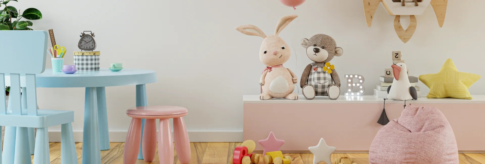 Children's playroom with a blue table, pink stools, and stuffed animals on a shelf.